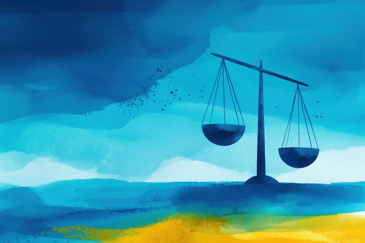 Watercolor image of scales of justice on a beach background